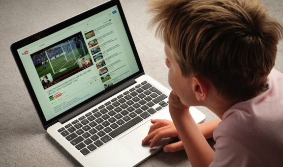 A Child watching Youtube videos on a laptop computer