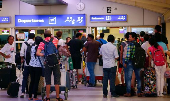 Tourists wait in the departures hall at Velana International Airport in Male
