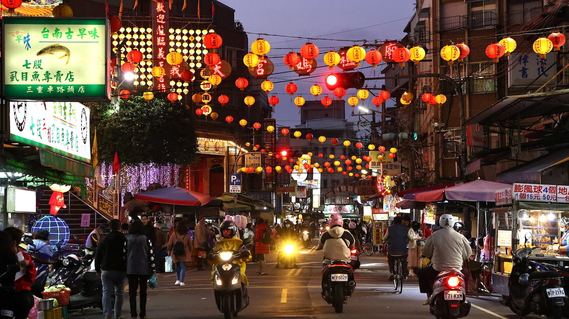 People pass by lit up lanterns during the Lunar New Year holiday in Taipei, Taiwan, February 14, 2021. REUTERS/Ann Wang