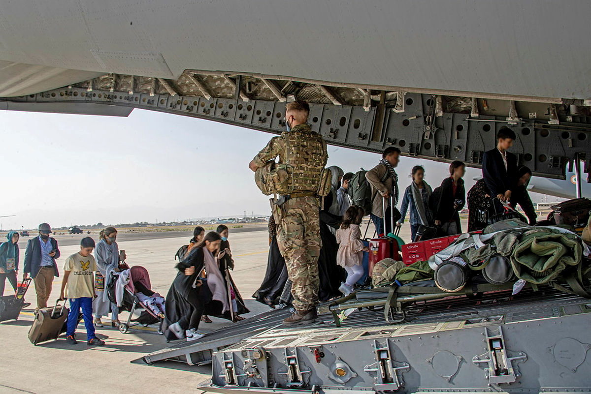 British citizens and dual nationals residing in Afghanistan board a military plane for evacuation from Kabul airport, Afghanistan August 16, 2021, in this handout picture obtained by Reuters on August 17, 2021.  LPhot Ben Shread/UK MOD Crown copyright 2021/Handout via REUTERS