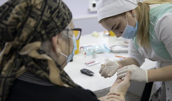 GROZNY, RUSSIA - DECEMBER 19, 2020: A woman undergoes antibody testing before an injection of Gam-COVID-Vac (marketed as Sputnik V) during COVID-19 vaccination at outpatient clinic No 2. Yelena Afonina/TASS (Photo by Yelena AfoninaTASS via Getty Images)
